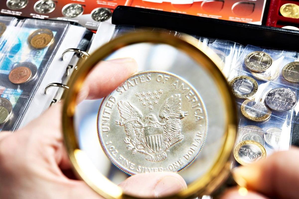A silver coin examined under a loupe