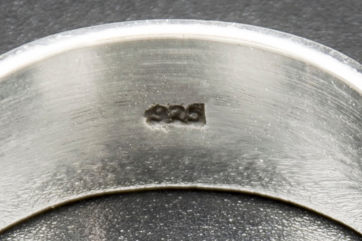 The inside of a silver ring stamped 925
