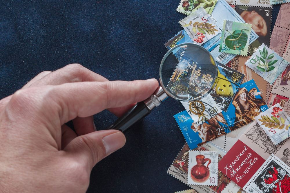 Looking at stamps under a magnifying glass